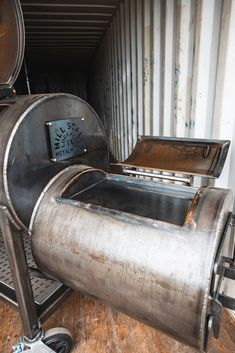 a large metal container sitting on top of a wooden floor