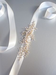 "This delicate romantic belt is beautifully hand made with fancy crystals twisted into this intricate design. The crystal design measures about 10\" long and 3 1/2\" wide. The design is attached to a 1 1/2\" wide double face satin ribbon measuring 150\" long. This belt is available in gold, silver or rose gold finish. - For the photo of the ribbon color options, please take a look here: https://www.etsy.com/listing/225025505/satin-ribbon-swatches-ribbon-color?ref=shop_home_active_16 - For the ma Floral Belt, Bridal Sash Belt, Crystal Belt, Crystal Hair Comb, Wedding Sash Belt, Belt Gold, Bridal Hair Clip, Bridal Comb, Wedding Belts