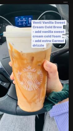 a person holding up a cup of coffee in their hand with the words vanilla sweet cream cold brew on it