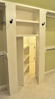 an empty walk in closet with white shelves and doors open to reveal another room that has no furniture