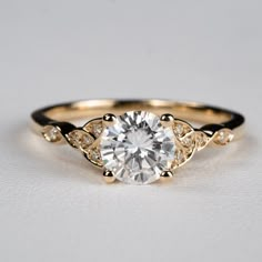 a gold engagement ring with a white diamond in the center