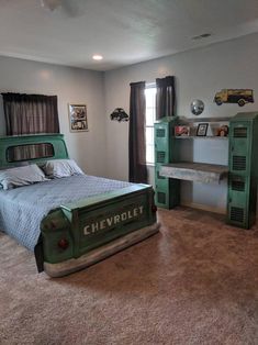 a bed room with a neatly made bed next to a desk and bookcases