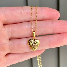 This necklace is 16" long and features a little heart shaped locket pendant. All materials are 24k gold plated and tarnish resistant. Dainty Heart Pendant Locket Necklace With Charm, Dainty Heart Locket Necklace With Charm, Valentine's Day Gift Locket Necklace For Mom, Adjustable Heart-shaped Engraved Necklaces, Personalized Adjustable Heart Pendant Locket Necklace, Nickel-free Open Heart Locket Necklace For Valentine's Day, Dainty Heart Locket Charm Necklace, Dainty Double Heart Locket Necklace With Charm, Heart-shaped Locket Necklace For Mom For Valentine's Day