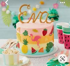 a cake with flamingos and pineapples on it is sitting on a table