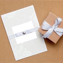 an open gift box with a white ribbon tied around it