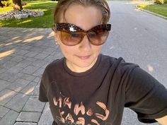 a woman with sunglasses on taking a selfie