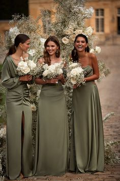 the bridesmaids are all dressed in green dresses and holding bouquets with white flowers