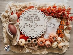 a baby announcement surrounded by pumpkins and other items on a wooden surface with the words'this fall, pumpkin watches football games and a baby bump due