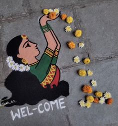 a welcome mat with flowers on the ground and a woman's face painted on it