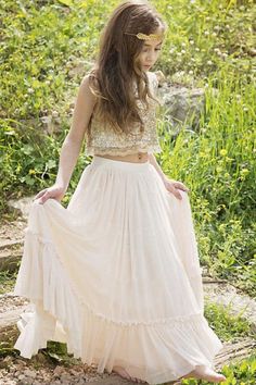 a woman in a white dress standing on the ground