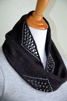 a black and white knitted scarf on a mannequin