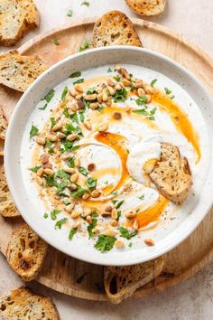 a white bowl filled with hummus and toasted bread