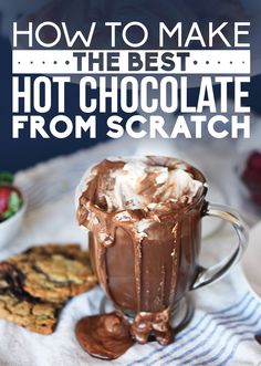 hot chocolate in a mug with whipped cream on top and cookies around the edge, text overlay reads how to make the best hot chocolate from scratch