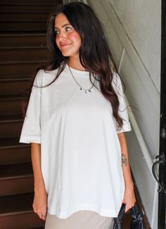 Tighter isn't always better, and our Noah Top say it best. An oversized tunic fit, this baggy tee features a classic crew neckline, stonewash, long-line hem and a drop shoulder. Wear with biker shorts, baggy jeans, swim and more, or wear as a dress if you're under 5'3" Fit: True to oversized fit. Mid stretch. Cadence is wearing a size S. 100% COTTON Baggy Tee, Outfit Inspired, Oversized Tunic, Baggy Jeans, Biker Shorts, Oversized Shirt, Shirt White, Drop Shoulder, Crew Neckline