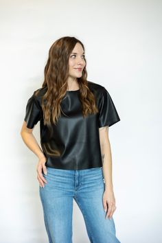 The Ezra Top from Steve Madden is made of a leather-like material and features a back zipper for easy wearing. Its slightly cropped design and short sleeves add a modern touch to any outfit. Stay stylish and comfortable with this versatile top. Materials: Imitation Leather - 100% Polyurethane Base - 100% Polyester Sizing: This top runs true to size, Abbie is wearing a small. Abbie’s Measurements: Height: 5'6" Waist: 26.5" Hips: 35" Bust: 32" Shoe: 8.5 Top: S Denim: 25/26 Jumpsuit Shorts Rompers, Running Tops, Short Jumpsuit, Denim Dress, Sweater Top, Blazer Jacket, Steve Madden, Dress Skirt, Bralette