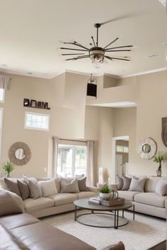 a living room filled with furniture and a chandelier