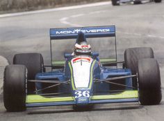 a man driving a race car on a track