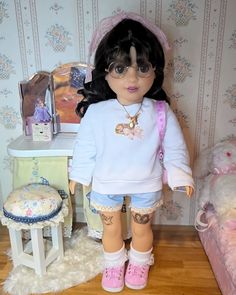 a doll is standing in front of a bed with her legs crossed and boots on