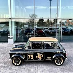 an old car is parked in front of a building