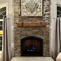 a living room filled with furniture and a fire place in front of a stone fireplace