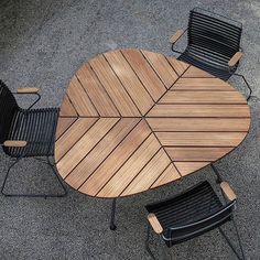 an outdoor table and chairs on the ground