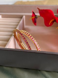 Set of 2 Bangles Ruby Color cz stone gold finish. Gold Ruby Bangle For Celebration, Ruby Gold Bangle For Celebration, Festive Gold Ruby Bracelets, Celebration Ruby Gold Bracelets, Traditional Gold Bangle With American Diamond, Gold Ruby Bangle For Festive Occasion, Gold Jeweled Bangle For Celebration, Festive Gold Bangle With Ruby, Festive Gold Ruby Bangle