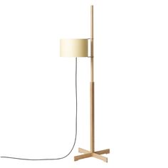 a wooden floor lamp with a white shade on the base and a black cord attached to it