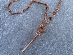 This 100% handmade copper necklace features intricate wire wrapped details throughout, reddish blue natural stone accents and a dangle pendant. This piece is a modern take on the Egyptian Ankh symbol, a sacred symbol of life. Wear alone or layer with your favorite necklaces. This eclectic boho statement necklace's eye-catching copper details are sure to become a favorite in any collection. 📐 SIZING:  Total length around is 22 inches. Pendant height is 3 inches, width is 3/4 inches. ✨ MATERIALS: Every item is 100% handmade and one-of-a-kind. The wire-wrapped copper jewelry is oxidized and polished to beautifully highlight details of the wirework. Since gemstones are unique, a slight variation from the colors pictured should be expected. 🙏🏼 CARE: This piece is made from natural copper wir Artisan Wire Wrapped Lariat Jewelry, Artisan Hand Wrapped Metal Necklace, Unique Wire Wrapped Lariat Necklace, Bohemian Adjustable Wire Necklaces, Wire Wrapped Metal Dangle Necklaces, Artisan Wire Wrapped Lariat Necklace, Artisan Wire Wrapped Dangle Necklace, Rust Colored Bohemian Metal Jewelry, Bohemian Adjustable Wire Necklace