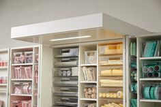 an organized closet with lots of drawers and items on the shelves in front of it