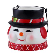 a ceramic snowman ornament with a black hat and red scarf around it's neck