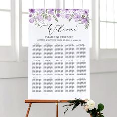 a seating sign with purple flowers on it