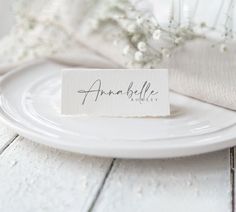 a place card sitting on top of a white plate