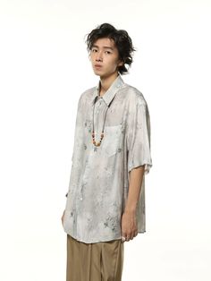 Make a lasting impression with our Metallic Sheen Abstract Print Oversized Button-Up Shirt, where style effortlessly meets comfort. Crafted for the fashion-forward, this piece boasts a unique metallic sheen and an abstract print that catches the eye. The oversized fit offers a relaxed vibe, complemented by the breathable fabric that ensures cool comfort on warm days. The shirt features a traditional collar, short sleeves, and an easy button-up closure, making it a standout addition to your wardr Casual Oversized Shirt With Abstract Print, Oversized Casual Top With Abstract Print, Casual Oversized Top With Abstract Print, Tailored Pants, Casual Trousers, Layered Look, Polished Look, Dressed Down, The Eye