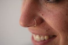 "A small and delicate hoop for nose ring or ear piercing in 14k yellow, rose or white solid gold This hoop nose ring is made of 14k solid gold and has delicate tiny dots almost all around it. it is light and comfortable and will be perfect for everyday use. This design is perfect for a variety of piercing locations: Septum / Tragus / Helix / Cartilage / Daith / Rook Get this cute nose ring and upgrade your everyday look. Features: * One 14K yellow, white or rose gold nose ring. Measurements: * I Boho Nose Ring, Piercing Locations, Cute Nose Rings, Rose Gold Nose Ring, Nose Ring Gold, Unique Nose Rings, Gold Nose Hoop, Gold Nose Ring, Piercing Cartilage