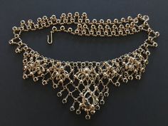 "This phenomenal necklace is extremely unique. I've never seen another one like it. Open back rhinestones are set in linked gold tone collets to create a fluid, lacey effect. Interconnected with this network of stones are floral elements also set with open back stones (primarily marquise shape). A large pear shaped stone provides a focal element. This is a really dramatic piece that I am having a hard time parting with :) CONDITION/SIZE: In excellent vintage condition. It measures 17\" from end Vintage Diamond Necklace With 17 Jewels For Evening, Antique Jeweled Necklaces For Wedding, Antique Jeweled Necklace For Wedding, Antique Chain Necklace For Wedding, Evening Diamond Jeweled Necklaces, Gold Diamond Rhinestone Necklace For Wedding, Wedding Rhinestone Necklace With Chain, Gold Diamond Necklace With Rhinestones For Wedding, Antique Wedding Jewelry With Chain Detail