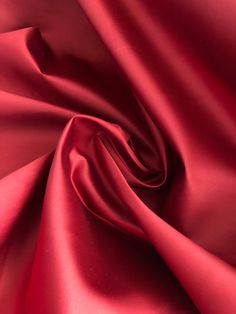 a close up view of a red satin fabric