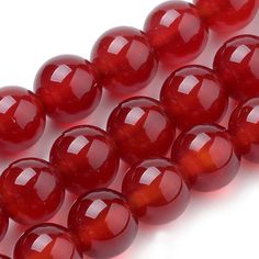 red agate beads on white background