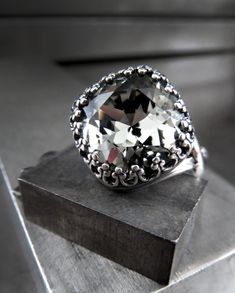 "Exquisite, timeless, classic. This romantic crystal ring features a sophisticated 'Black Diamond' crystal in a perfectly-faceted, cushion-cut style. The sparkling charcoal grey crystal is enveloped in a highly-detailed, vintage-inspired antiqued silver plated bezel. The antiqued silver-plated ring comfortably adjusts to fit approx. sizes 6 to 9. - Cushion-cut 'Black Diamond' crystal: 1/2\" square (12mm) - Antiqued silver plated adjustable ring - Adjusts to fits approx. sizes 6 to 9 Coordinating Beautiful Promise Rings, Trio Ring, Swarovski Crystal Rings, Wedding Bridesmaid Jewelry, Wedding Bridesmaid, Crystal Ring, Silver Crystal, Plated Ring, Diamond Crystal