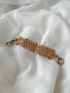 A fascinating Victorian 10ct pink gold watch fob containing both a dog clip and C clasp. What’s specifically intriguing about it are the rows of 32 miniature arrows, pointing outward from the central rhombus of the symmetrical geometric design. It has a delightful heft to it, and beautiful simple cast details which bring the piece to life. It would would have been worn as a piece of ornamentation across the exterior of a vest or jacket in true masculine peacocking jewel form. Materials and Featu Timeless Link Bracelet Jewelry, Timeless Link Gold Bracelet, Rose Gold Rectangular Jewelry With Bracelet Strap, Rose Gold Rectangular Bracelet Jewelry, Timeless Gold Metal Bracelet, Timeless Gold Bracelet With Rectangular Links, Formal Bracelet Jewelry With Hooks And Links, Timeless Formal Bracelets With Spring Ring Clasp, Timeless Formal Bracelet With Spring Ring Clasp