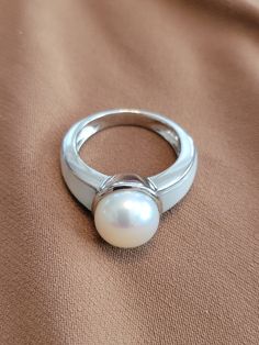 The ring has a 10mm white freshwater pearl center with a 5mm thick gray opal on the front of the band.  Solid 925 silver filled. Ruby Bracelet, Cameo Necklace, White Freshwater Pearl, White Band, Genoa, Floral Earrings, Locket Necklace, Pearl Ring, Rings Statement