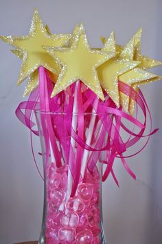 pink and yellow lollipops in a vase with stars