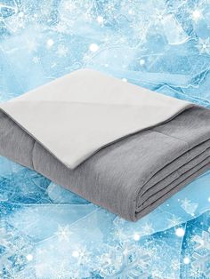 a blanket is laying on top of an ice - flaked surface with snowflakes in the background