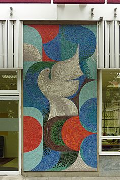 a building that has a large mosaic on the side of it's front door