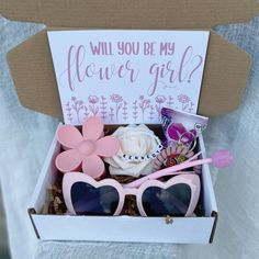 a box filled with pink sunglasses and flowers