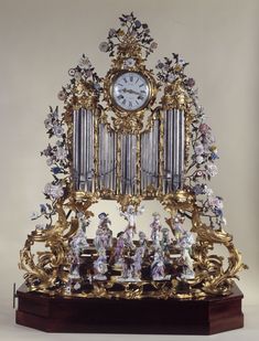 an elaborate clock with figurines on it