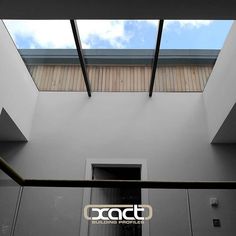 an open door leading to a building with skylights above it and the words accta on the wall