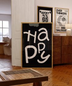 a black and white sign that says happy on it in the middle of a room