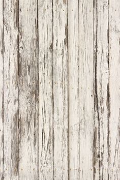 an old white wooden wall with peeling paint