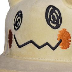 a white hat with an orange and black design on it