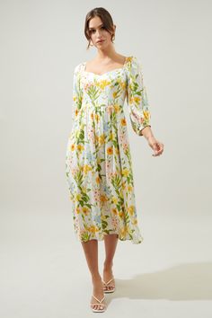 Spring garden dreams. This floral midi is perfect for the spring events ahead of us. It features longer balloon sleeves that frame a sweetheart neckline and fitted bodice. The skirt sits higher on the waist, with gathering along the waistline to create a flowy element. Add a some strappy heels and a woven mini bag to complete the look.- Sweetheart neckline- Smocked back- Zipper- Square back- Color: Green Yellow BlueSize + Fit - Model is 5'9" and wearing size XS- Measurements taken from size S - Green Puff Sleeve Midi Dress With Floral Print, Green Floral Print Midi Dress With Puff Sleeves, Spring Floral Print Dress With Balloon Sleeves, Green Puff Sleeve Midi Dress For Garden Party, Green Puff Sleeve Dress For Garden Party, Puff Sleeve Dress With Floral Print For Garden Party, Spring Brunch Puff Sleeve Dress With Sweetheart Neckline, Puff Sleeve Dress With Sweetheart Neckline And Floral Print, Garden Party Puff Sleeve Floral Dress With Fitted Bodice